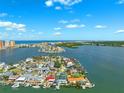 Stunning aerial view of waterfront home with boat docks and lush landscaping on a sunny day at 139 Wall St, Redington Shores, FL 33708