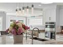 The kitchen features a large island with pendant lighting, granite countertops, stainless appliances, and ample space at 139 Wall St, Redington Shores, FL 33708