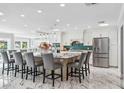 Bright, spacious kitchen with large island, modern appliances, and elegant marble floors, perfect for entertaining at 139 Wall St, Redington Shores, FL 33708