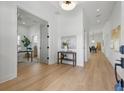 Bright foyer featuring hardwood floors and modern decor, leading to the home office and dining area at 1514 55Th N Ave, St Petersburg, FL 33703