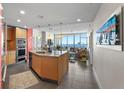 Modern kitchen with granite countertops, stainless steel appliances, a large island, and a view of the ocean at 175 1St S St # 2005, St Petersburg, FL 33701