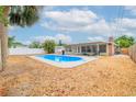 Spacious backyard featuring a refreshing blue swimming pool, ideal for outdoor enjoyment and relaxation at 1758 Southview Rd, Largo, FL 33770