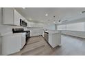 Modern kitchen with stainless steel appliances, white cabinets, and quartz countertops at 1835 Nevada Ne Ave, St Petersburg, FL 33703