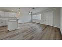 Open-concept living area featuring hardwood floors and modern lighting fixtures at 1835 Nevada Ne Ave, St Petersburg, FL 33703