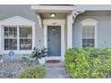 Welcoming home entrance featuring a lovely door with wreath and stylish, low maintenance landscaping at 2362 Lake Woodberry Cir, Brandon, FL 33510