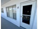 Building entrance featuring unit number 53, a screen door, and windows at 2469 Franciscan Dr # 53, Clearwater, FL 33763
