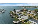 Waterfront property with boat dock, swimming pool, and lush tropical landscaping at 2540 S Shore Se Dr, St Petersburg, FL 33705