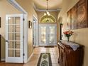 Grand foyer with tile flooring, and decorative glass double-door entry at 2613 Bonterra Blvd, Valrico, FL 33594
