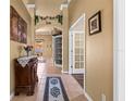 Inviting hallway features neutral paint, decorative archway, and tile flooring at 2613 Bonterra Blvd, Valrico, FL 33594