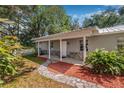 Inviting front entrance with a stone walkway and covered porch at 34651 Appaloosa Trl, Zephyrhills, FL 33541