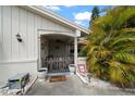 Inviting front porch with decorative accents, potted plants, and a cozy seating area at 4209 Stratfield Dr, New Port Richey, FL 34652