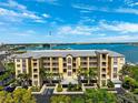 Beautiful exterior shot of the condo complex with lush landscaping, stunning views, and convenient parking at 425 150Th Ave # 2501, Madeira Beach, FL 33708