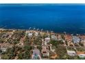 Aerial view of waterfront homes and docks with access to stunning ocean views at 508 N Mayo St, Crystal Beach, FL 34681