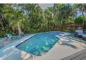 Backyard pool with pavers, mature landscaping, and outdoor lounge chairs at 508 N Mayo St, Crystal Beach, FL 34681