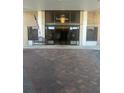 Front entrance to the Essex House building with tiled walkway and glass doors at 5200 Brittany S Dr # 1502, St Petersburg, FL 33715