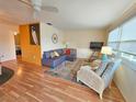 Cozy living room with comfortable seating, stylish rug, and plenty of natural light from a window at 5935 30Th S Ave # 308, Gulfport, FL 33707