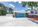 View of the property featuring a wide driveway leading to the home's garage at 6515 Dimarco Rd, Tampa, FL 33634