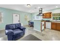 Bright kitchen area with stainless steel appliances, tile floors, and blue accent walls at 6515 Dimarco Rd, Tampa, FL 33634