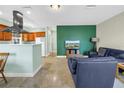 Cozy living room area with neutral walls and tile flooring and adjacent kitchen at 6515 Dimarco Rd, Tampa, FL 33634