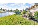 A serene water view complements the lush lawn of this gorgeous property at 6994 Country Lakes Cir, Sarasota, FL 34243
