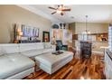 Open-concept living area with hardwood floors and views of the kitchen bar seating at 7508 S Mascotte St, Tampa, FL 33616