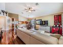 Inviting living room featuring hardwood floors, vaulted ceilings, and ample natural light at 7508 S Mascotte St, Tampa, FL 33616