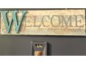 Charming 'Welcome to the Beach' sign displayed above a unit number adding a personal touch at 880 Mandalay Ave # S511, Clearwater Beach, FL 33767