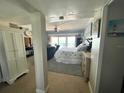 Bright main bedroom with king bed, seating area and sliding glass doors leading to ocean view balcony at 880 Mandalay Ave # S511, Clearwater Beach, FL 33767