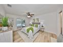 Light-filled bedroom with ceiling fan and sliding doors to the pool area at 940 Woodland Dr, Palm Harbor, FL 34683