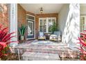 Inviting front porch with brick flooring, comfortable seating, and stylish decor for outdoor enjoyment at 10011 Parley Dr, Tampa, FL 33626
