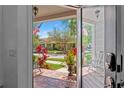 View from inside home looking out to a landscaped front porch and a well-manicured street at 10011 Parley Dr, Tampa, FL 33626