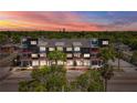 A modern condo building with orange balconies at dusk at 11 29Th N St, St Petersburg, FL 33713
