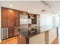 Modern kitchen features stainless steel appliances and a large center island with granite countertops at 1120 E Kennedy Blvd # 615, Tampa, FL 33602