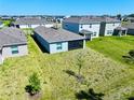 Aerial view of the backyard featuring a screened lanai, offering a private outdoor space for relaxation and entertainment at 11268 Fieldstone Dr, Palmetto, FL 34221