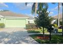 Well-kept single-story home featuring a two-car garage and tidy landscaping at 11468 Captiva Kay Dr, Riverview, FL 33569