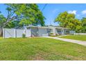Charming home with a well-maintained lawn, driveway, and vibrant landscaping at 1290 Bertland Way, Clearwater, FL 33755