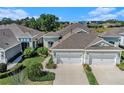 Gorgeous aerial view of townhomes with manicured landscaping and attached garages at 13539 Circa Crossing Dr, Lithia, FL 33547