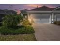 Charming townhome featuring an attached two-car garage and manicured landscaping at 13539 Circa Crossing Dr, Lithia, FL 33547