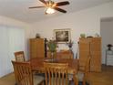Formal dining room with a wooden table, seating for six, and decorative accents at 1395 Heather Ridge Blvd, Dunedin, FL 34698