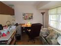 Cozy office space with a desk, filing cabinet, and a comfortable seating area at 1395 Heather Ridge Blvd, Dunedin, FL 34698