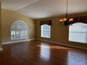 Bright living room features hardwood floors, large windows with shutters, and a decorative chandelier at 1415 Saddle Gold Ct, Brandon, FL 33511
