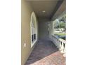Charming front porch with brick flooring, columns, and white railing, providing a welcoming entrance at 1415 Saddle Gold Ct, Brandon, FL 33511