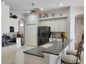Spacious kitchen featuring a breakfast bar, stainless steel appliances, and tile flooring at 16106 Bridgedale Dr, Lithia, FL 33547