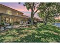 This home features a relaxing backyard with a patio, outdoor seating, and serene pond views at 17537 Fairmeadow Dr, Tampa, FL 33647