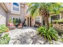 Inviting courtyard with brick pavers, lush greenery, and comfortable seating area at 17537 Fairmeadow Dr, Tampa, FL 33647