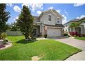 Lovely two-story home with a brick driveway, beautiful lawn, and enhanced landscaping features at 19278 Roseate Dr, Lutz, FL 33558