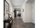 Inviting home hallway with wood-look floors and decoratively appointed console table at 19278 Roseate Dr, Lutz, FL 33558