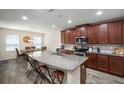Open kitchen with a large island, granite countertops, and stainless steel appliances at 19278 Roseate Dr, Lutz, FL 33558
