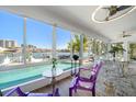Bright dining room with pool and water views and unique decor at 213 Harrison Ave, Belleair Beach, FL 33786