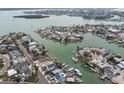 Aerial view of waterfront properties with boat docks and canal access, near the ocean at 301 Boca Ciega Dr, Madeira Beach, FL 33708